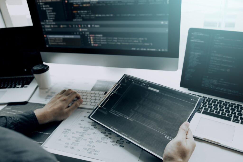 Asian man working code program developer computer web development working design software on desk in office.